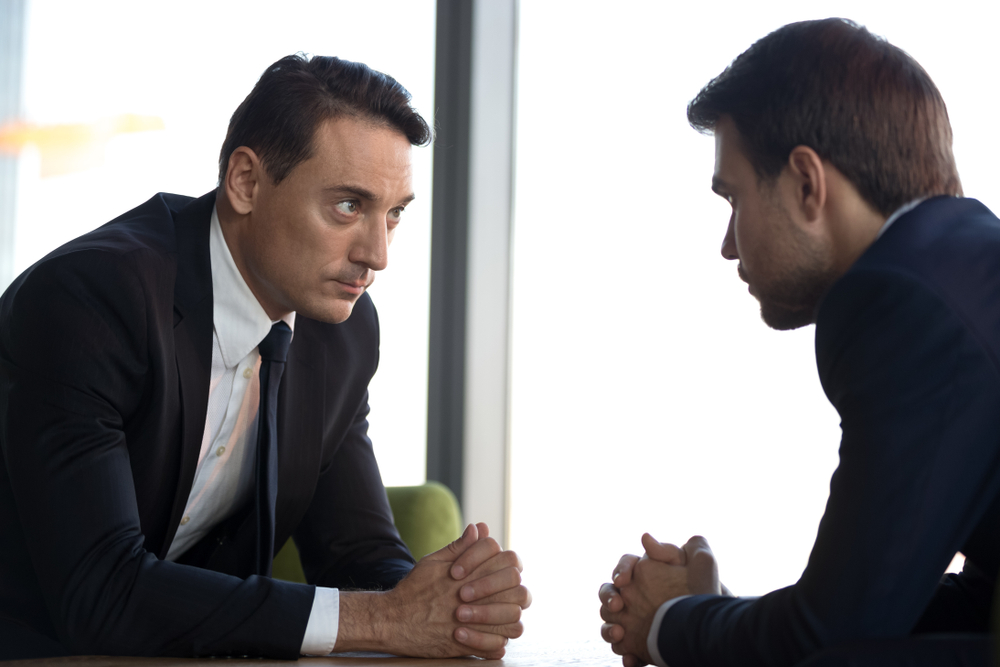 A stern lawyer talking to a client